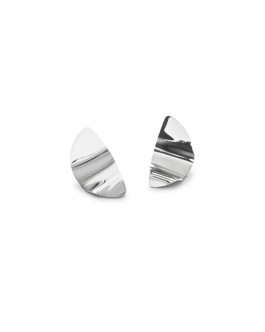 A pair of sculptural sterling silver crescent-shaped stud earrings with a textured, wavy surface, displayed on a clean white background.