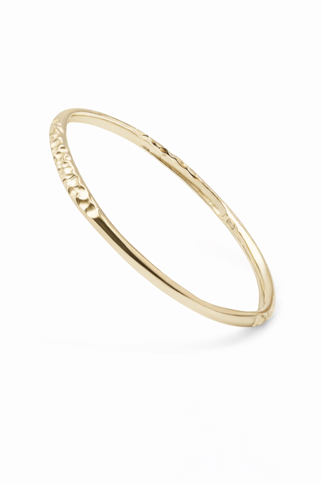 Sculptural, textured bangle in 9 carat yellow gold.