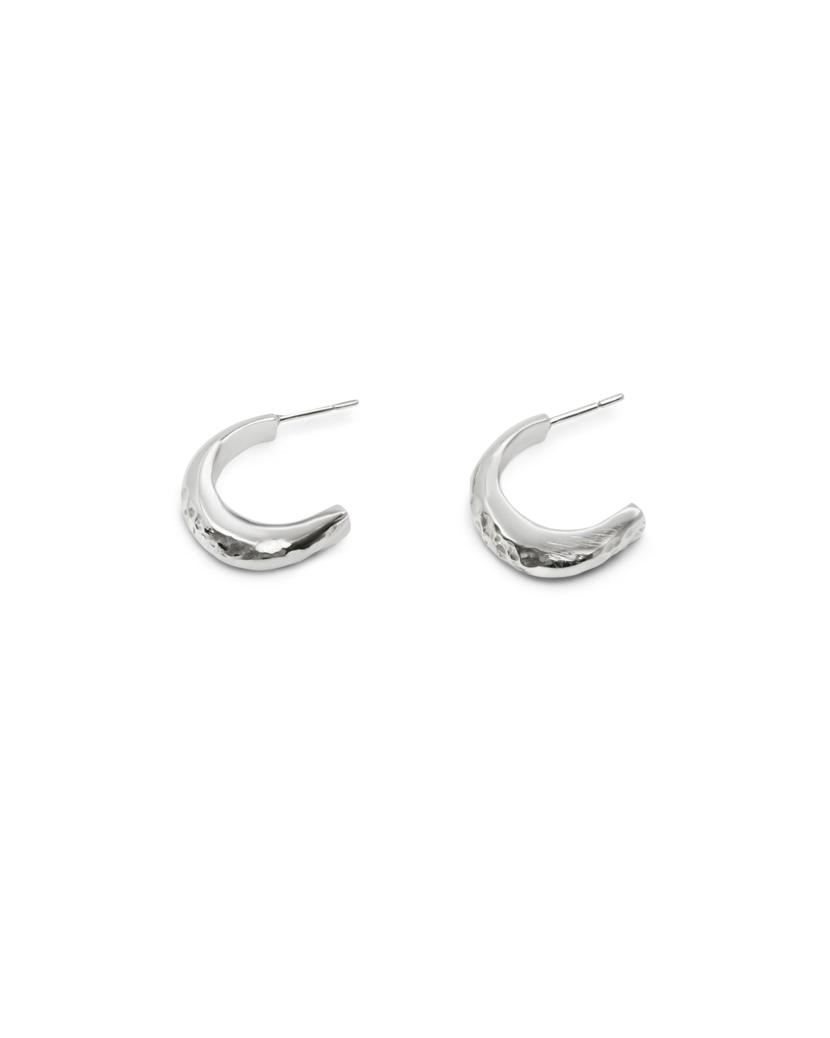 Sculptural textured sterling silver hoop earrings on a white background