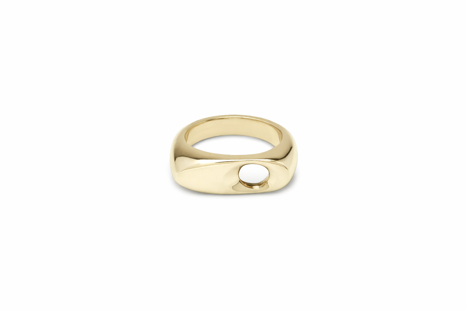Gold sculptural ring with a round cutout on a white background